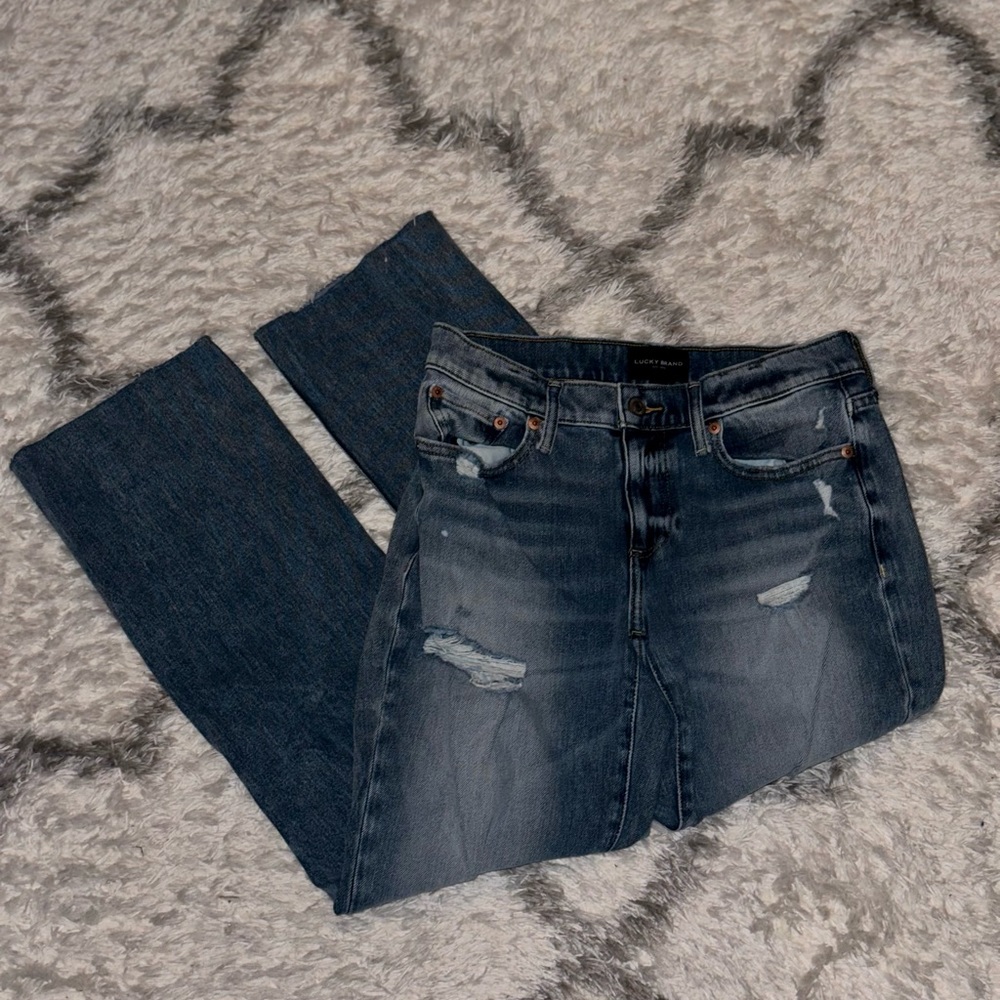 Lucky Brand medium/light wash jeans with small distress in size 2/26R